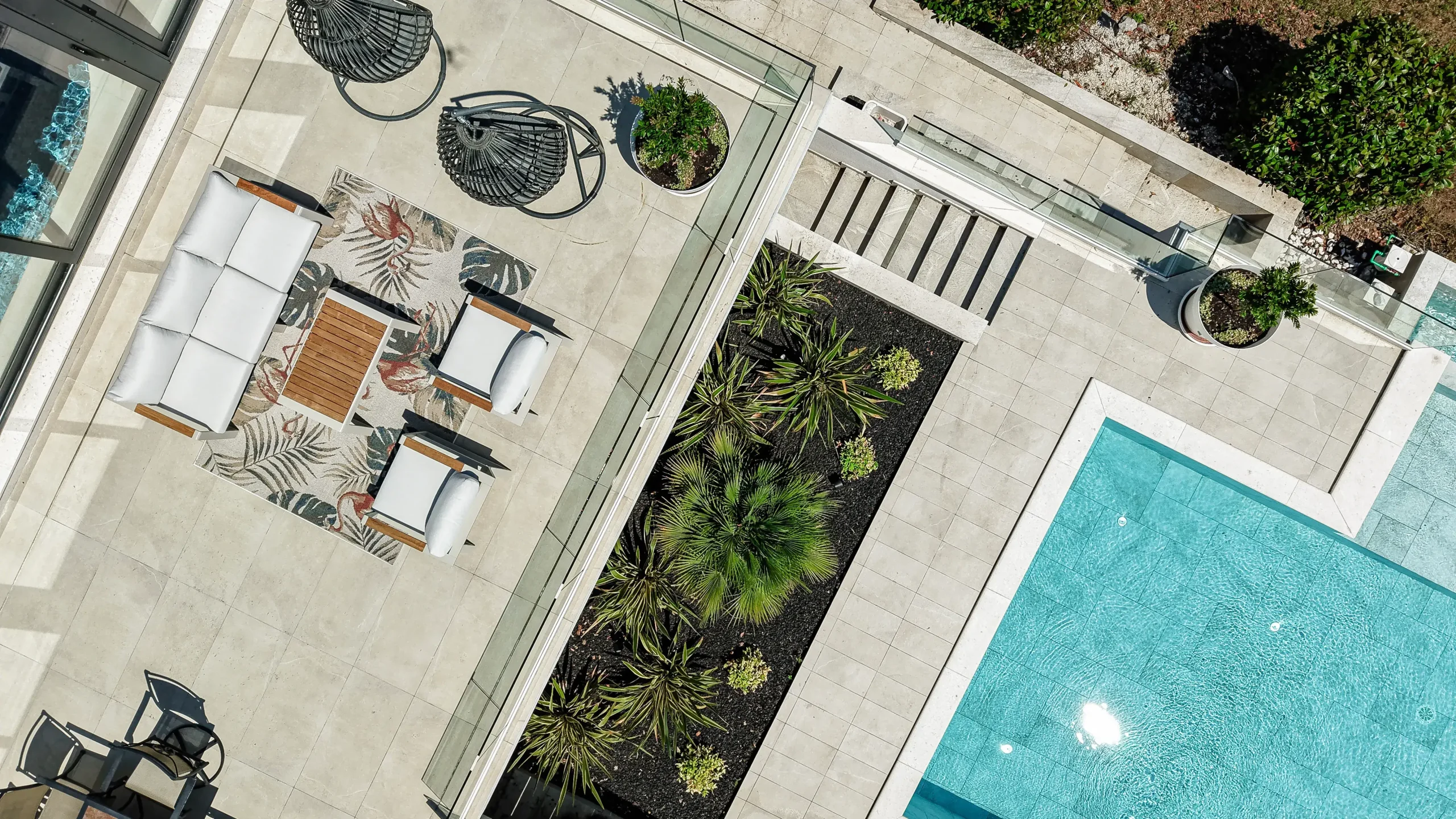 Aerial view of Villa Theodor's terrace with lounge seating and pool overlooking the hills above Opatija