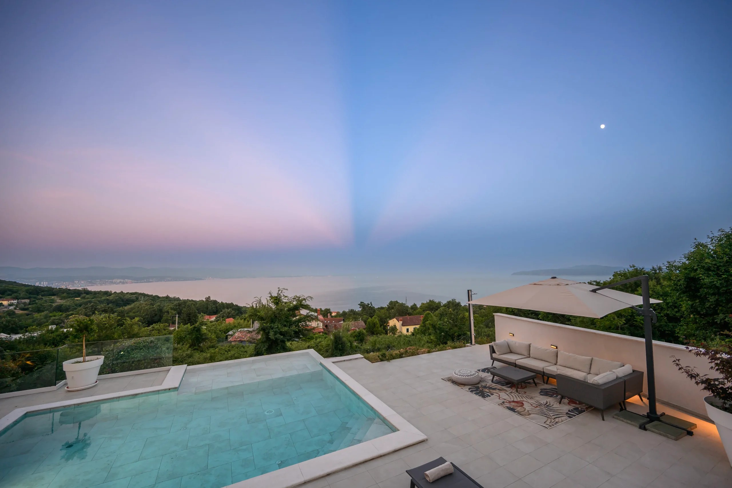 Panoramic twilight view of the Kvarner Bay and Opatija coastline from Villa Theodor's terrace lounge